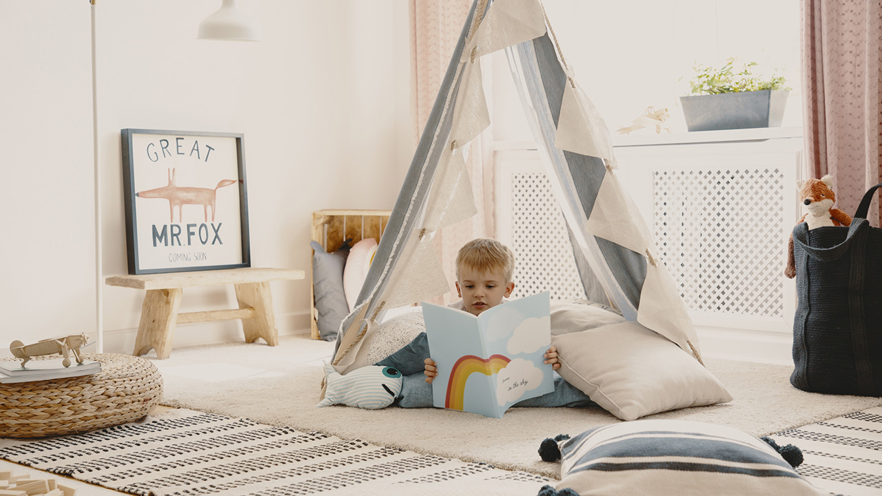 Kid reading in a cozy space.